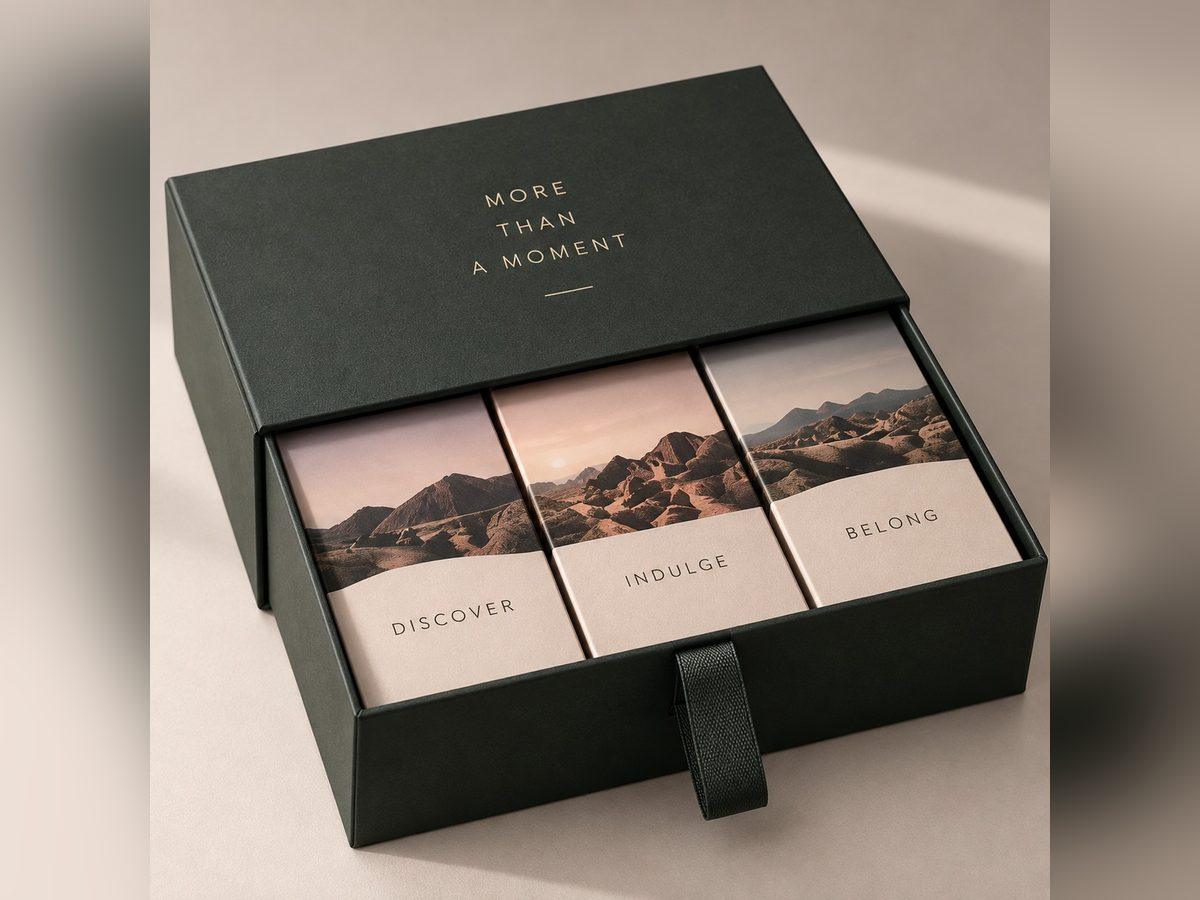 Dark sliding drawer box with a printed sleeve and three compartments of tea